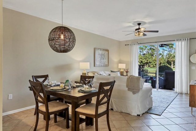 dining room with ceiling fan, ornamental molding, light tile patterned flooring, and baseboards