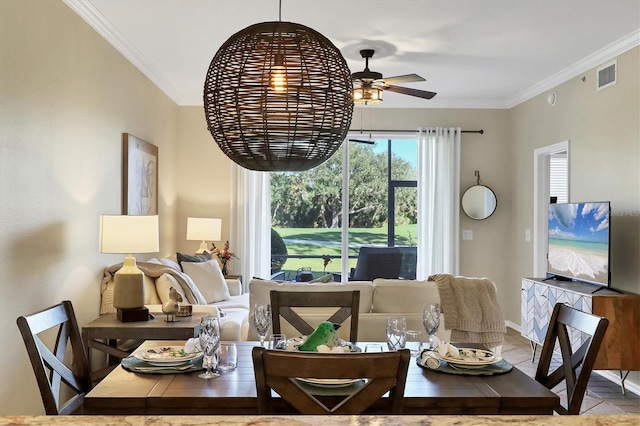 dining space with visible vents, a ceiling fan, and crown molding