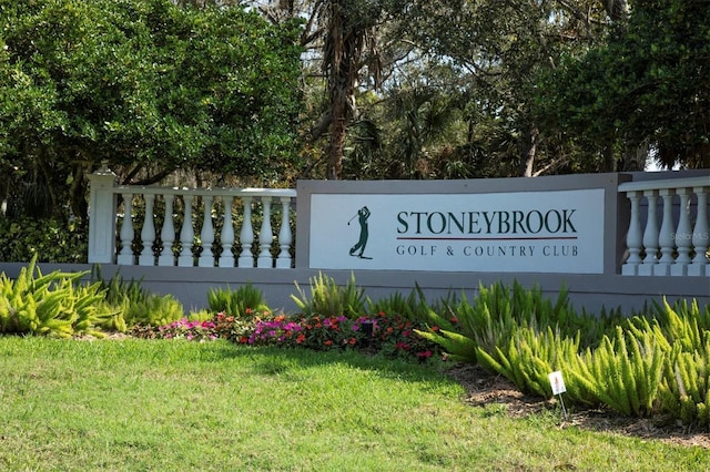 community / neighborhood sign with a lawn