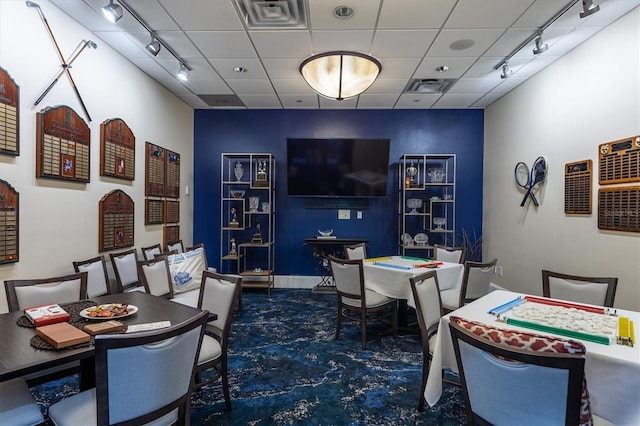 office featuring visible vents, a drop ceiling, and track lighting