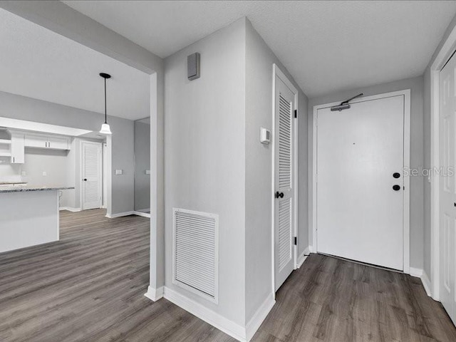 corridor with dark wood-type flooring