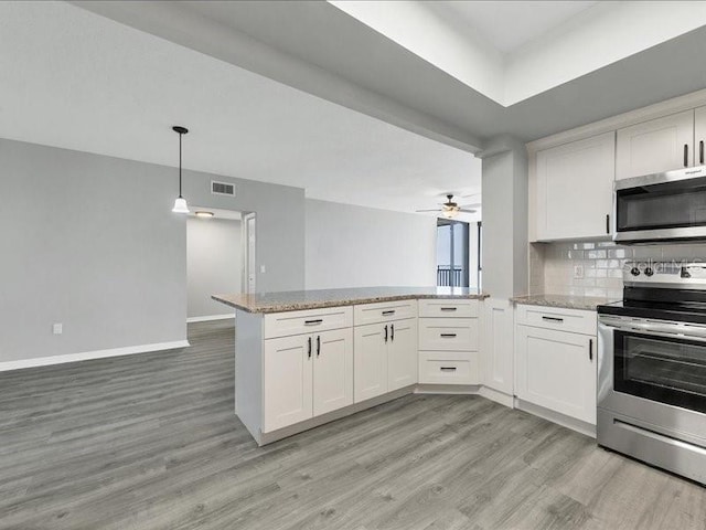 kitchen featuring pendant lighting, white cabinets, light hardwood / wood-style flooring, appliances with stainless steel finishes, and kitchen peninsula