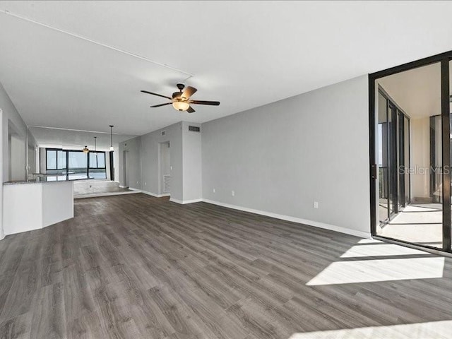 unfurnished living room featuring ceiling fan and wood-type flooring