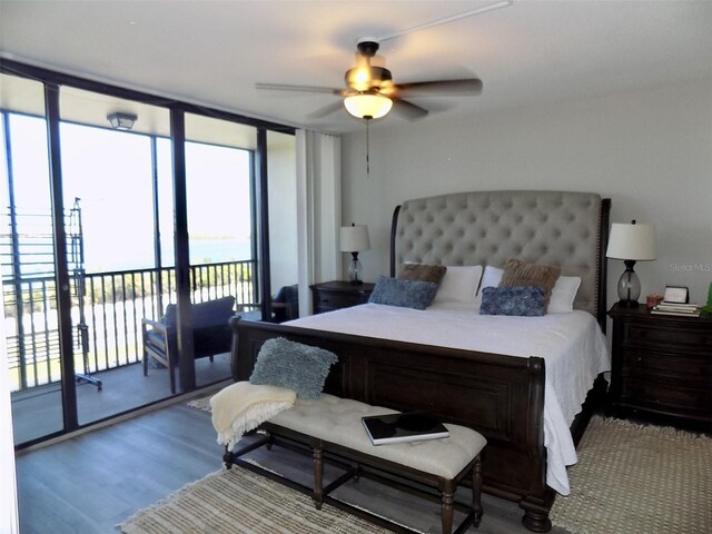 bedroom with expansive windows, light wood-type flooring, access to outside, and ceiling fan