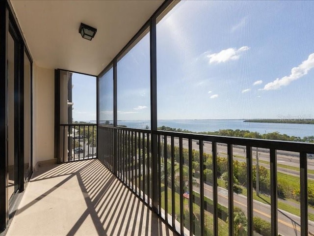 unfurnished sunroom featuring a water view