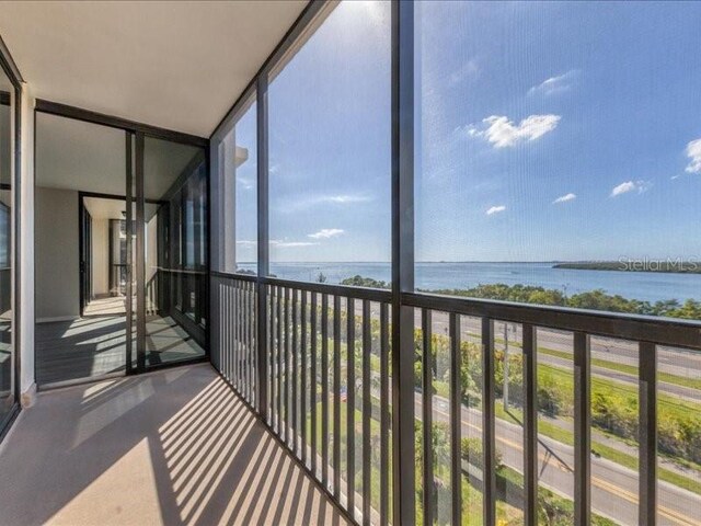 unfurnished sunroom featuring a water view