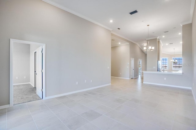 empty room with light tile patterned flooring, ornamental molding, and an inviting chandelier