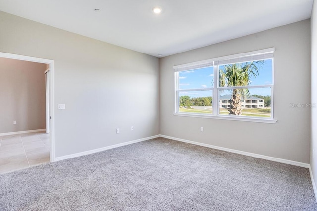 spare room with light colored carpet