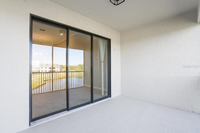 view of patio / terrace with a water view and a balcony