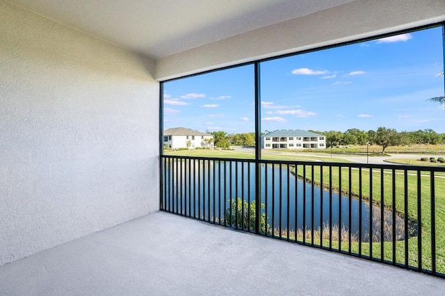 unfurnished sunroom with a water view