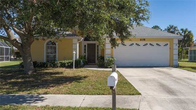 view of front of property featuring a garage and a front yard