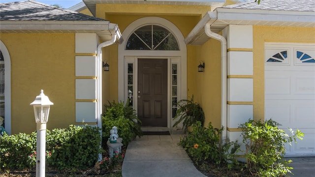 view of exterior entry featuring a garage