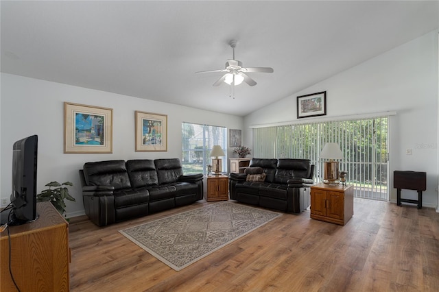 living room featuring hardwood / wood-style floors, high vaulted ceiling, and ceiling fan