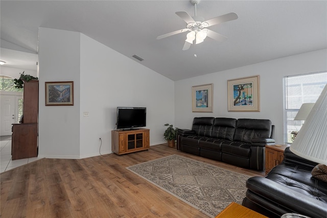 living room featuring light hardwood / wood-style flooring, ceiling fan, and lofted ceiling