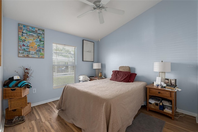 bedroom featuring ceiling fan, wood-type flooring, and vaulted ceiling