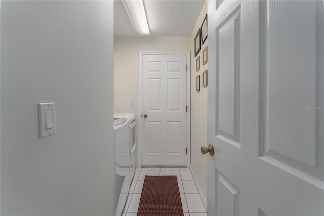 laundry room featuring light tile patterned floors and washing machine and dryer