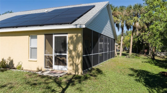 view of home's exterior featuring a yard and solar panels