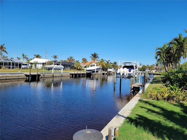 dock area with a water view and a yard