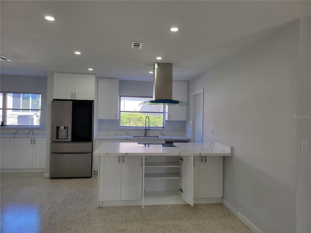 kitchen featuring kitchen peninsula, stainless steel refrigerator with ice dispenser, sink, white cabinets, and island range hood