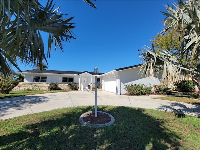 view of front of home featuring a front yard and a garage