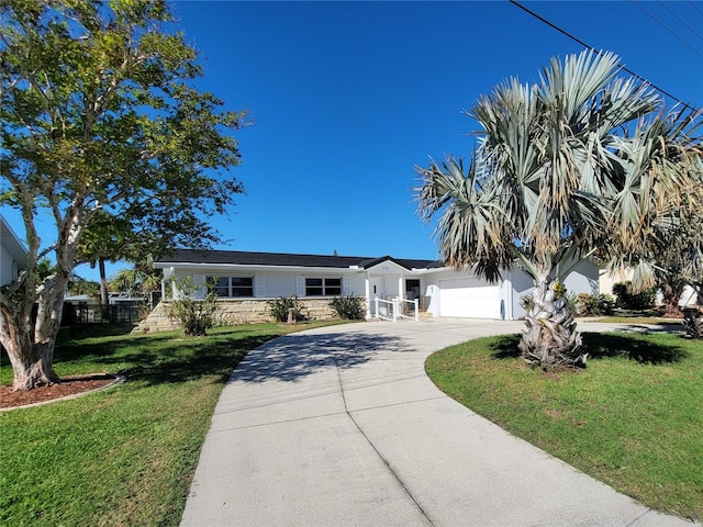 view of front of home featuring a garage and a front yard