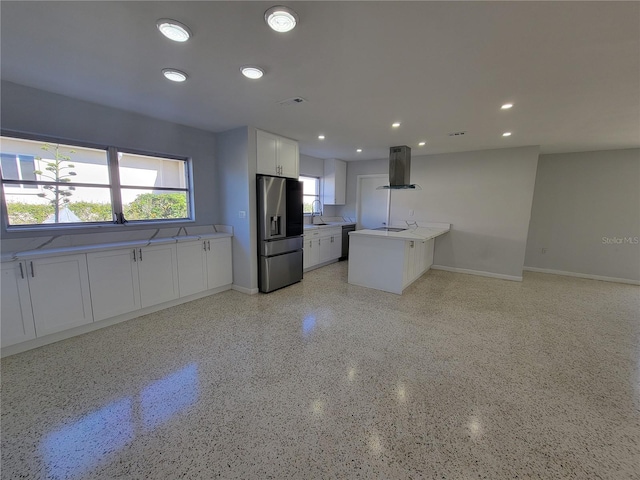 kitchen with stainless steel fridge with ice dispenser, white cabinetry, kitchen peninsula, island exhaust hood, and black dishwasher