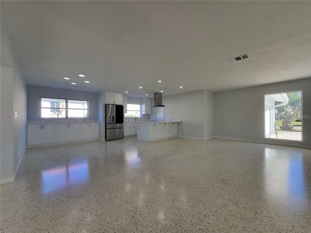 unfurnished living room featuring sink