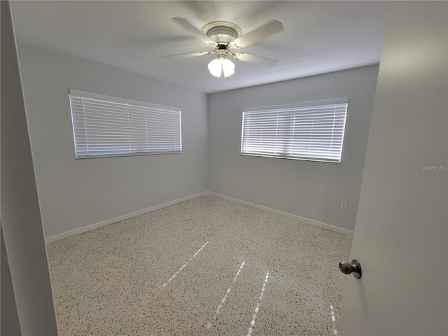 spare room with ceiling fan