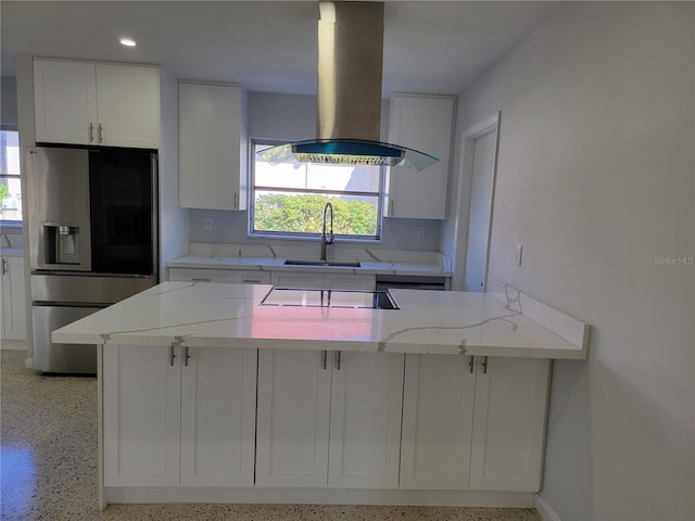 kitchen with stainless steel refrigerator with ice dispenser, kitchen peninsula, white cabinets, and island exhaust hood