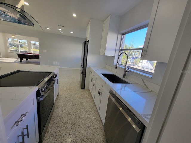 kitchen with white cabinetry, stainless steel appliances, billiards, light stone counters, and sink