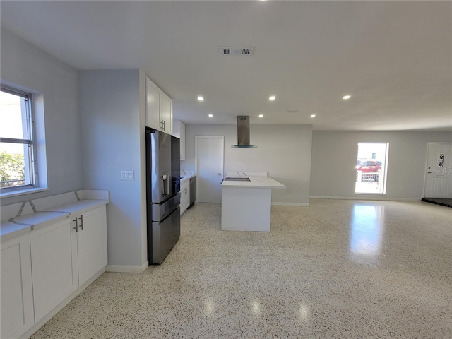 kitchen featuring island exhaust hood, fridge with ice dispenser, white cabinets, and light stone countertops