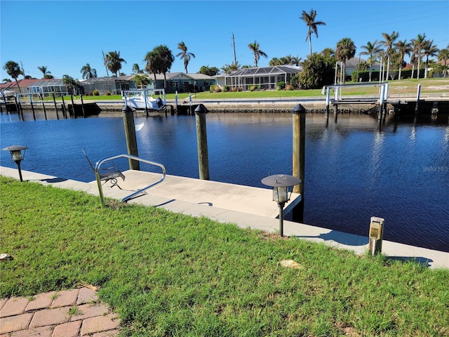 view of dock featuring a water view and a lawn