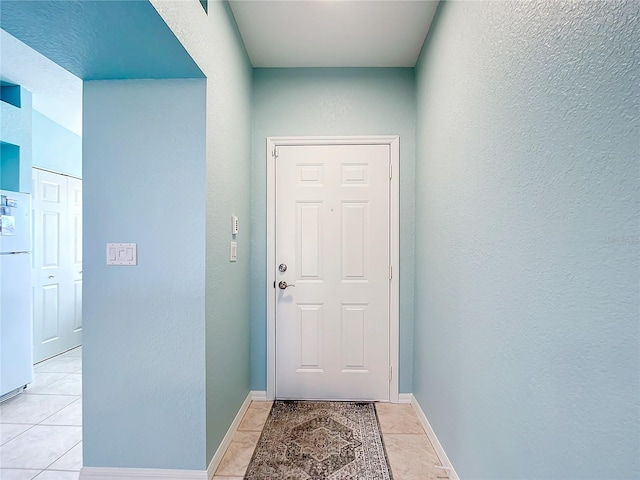 doorway featuring light tile patterned flooring