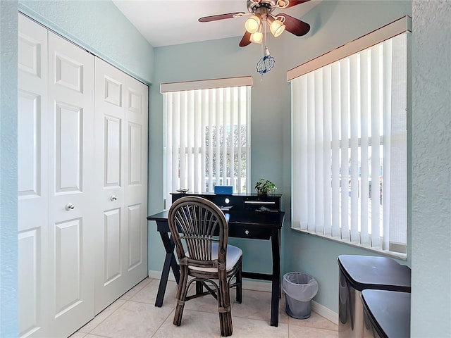 tiled office featuring ceiling fan