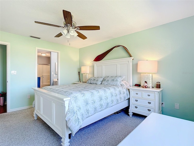 carpeted bedroom featuring ensuite bath and ceiling fan