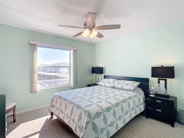 bedroom featuring light colored carpet and ceiling fan