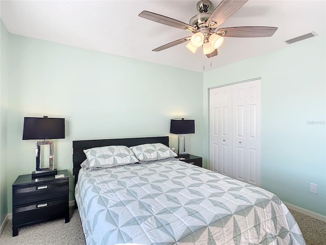 bedroom featuring ceiling fan, light carpet, and a closet