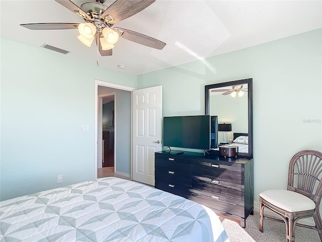 bedroom with light carpet and ceiling fan