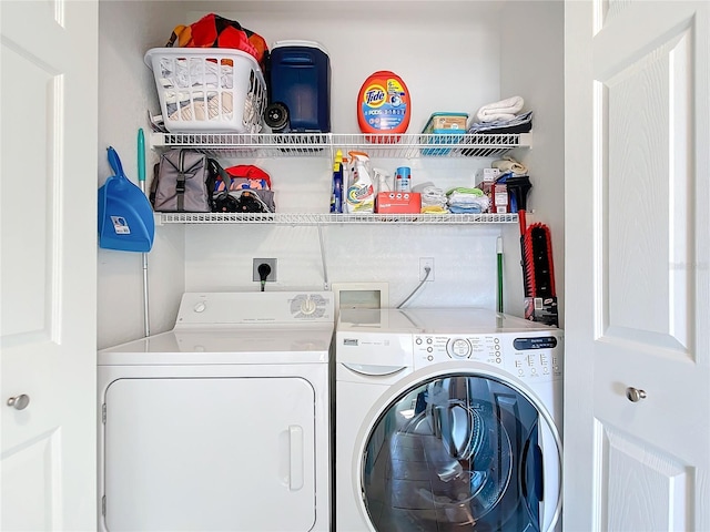 clothes washing area featuring separate washer and dryer