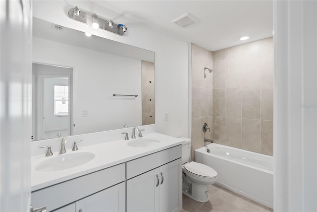 full bathroom featuring tile patterned flooring, tiled shower / bath combo, toilet, and vanity