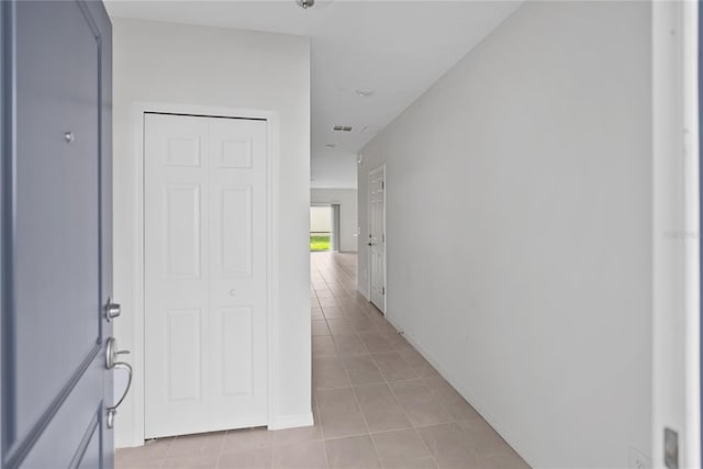 hallway featuring light tile patterned floors