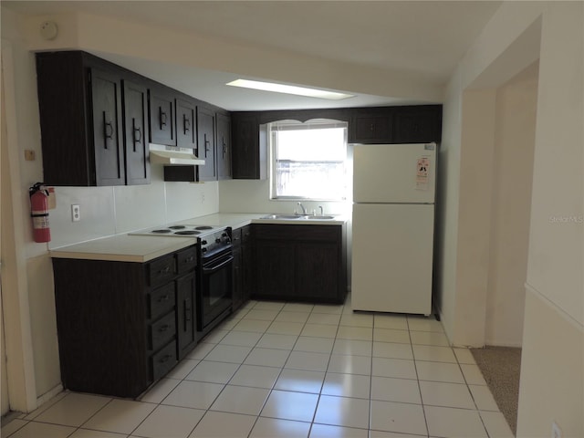 kitchen with black range with electric cooktop, white refrigerator, light tile patterned floors, and sink