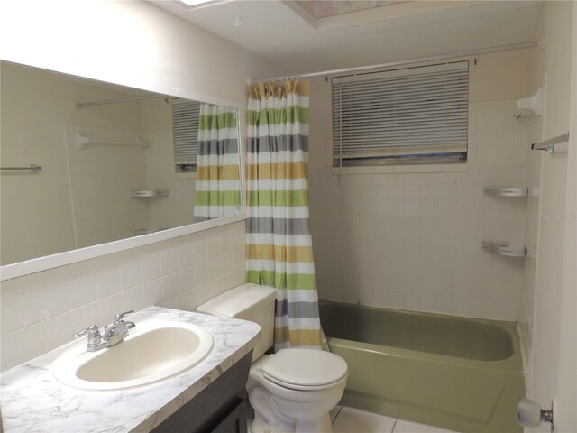 full bathroom with backsplash, vanity, shower / bath combo with shower curtain, tile walls, and toilet