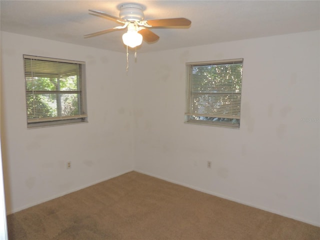 carpeted empty room with ceiling fan