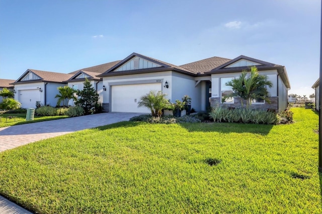 single story home with a garage and a front lawn