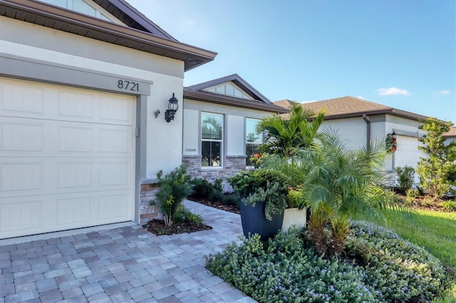 doorway to property with a garage