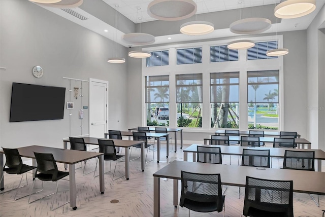 dining room featuring a towering ceiling