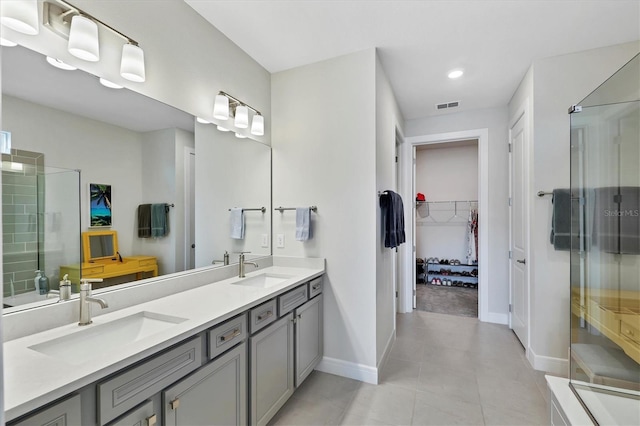 bathroom with tile patterned flooring, walk in shower, and vanity