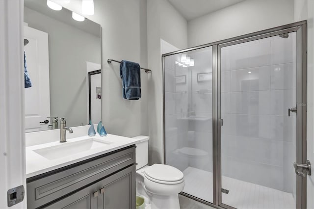 bathroom featuring walk in shower, vanity, and toilet