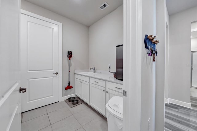 bathroom with tile patterned flooring and vanity